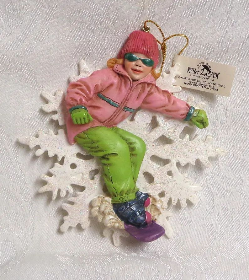 kurt-s-adler-girl-snowboarding-hanging