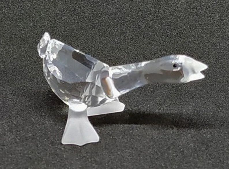 swarovski-duck-reaching-down-lead